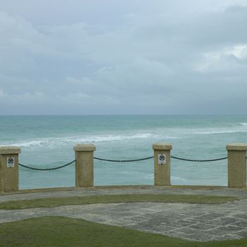 Pillar and chain fence overlooking the tropical ocean