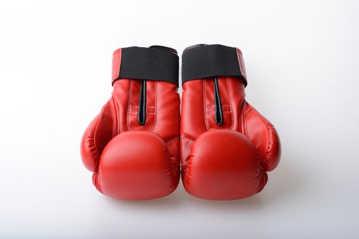 Pair of red leather boxing gloves on white background