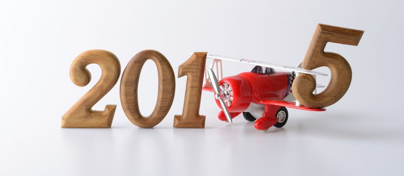 New year 2015 sign made by wooden number and red airplane