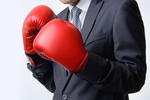 businessman with red boxing glove ready to fight with problem, business concept