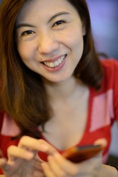 smile asian woman have fun and enjoy with mobile phone