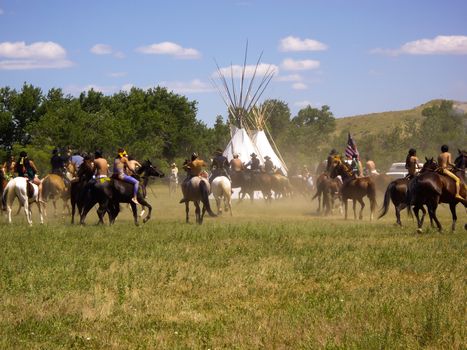 Crow Agency, Montana USA - June 27, 2009: Old and Modern worlds meet at Battle of the Little Bighorn Re-enactment. Reenactment of the Battle of the Little Bighorn known as Custer's Last Stand. Young American Indians of the Arapahoe, Cheyenne and Lakota tribes battle the U.S. 7th Cavalry soldiers.