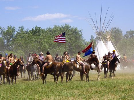 Crow Agency, Montana USA - June 27, 2009: American Indians capture the flag at Battle of the Little Bighorn reenactment.
This annual reenactment is held at the Crow Agency near Hardin, Montana and is a realistic portrayal of Custer's Last Stand of 1876. It attracts many visitors from all over the world who are captivated by the history of the American Indian Tribes.