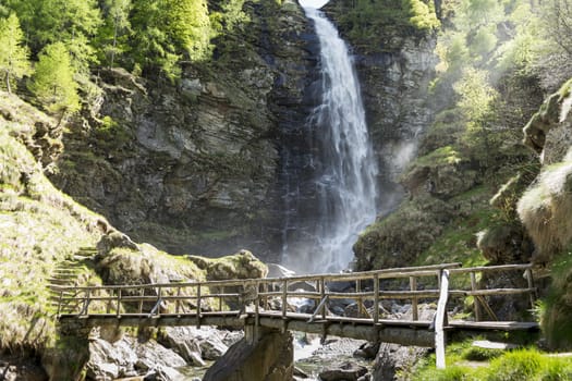 wooden bridge over the river and waterfall, Switzerland