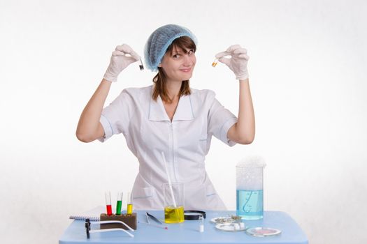 Young beautiful girl posing chemical experiments in the laboratory