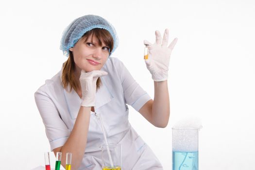 Young beautiful girl posing chemical experiments in the laboratory