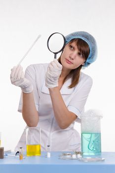 Young beautiful girl posing chemical experiments in the laboratory