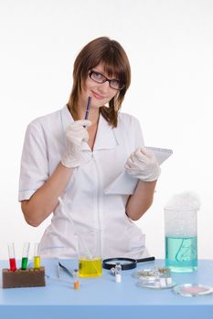 Young beautiful girl posing chemical experiments in the laboratory