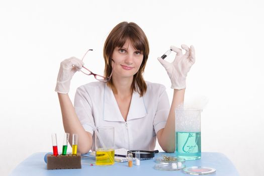 Young beautiful girl posing chemical experiments in the laboratory
