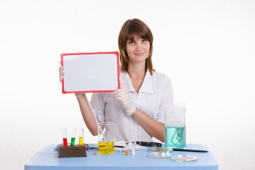 Young beautiful girl posing chemical experiments in the laboratory