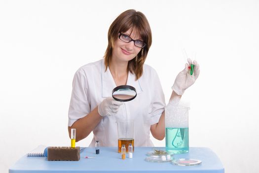 Young beautiful girl posing chemical experiments in the laboratory