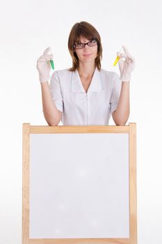 Chemist with test tubes stands at the blackboard with advertising