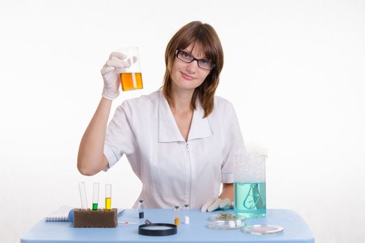 Young beautiful girl posing chemical experiments in the laboratory