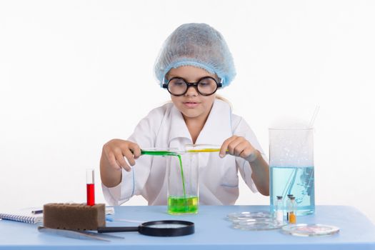 Girl sitting in chemistry class and makes the simplest experiments