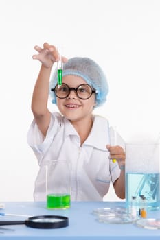 Girl sitting in chemistry class and makes the simplest experiments