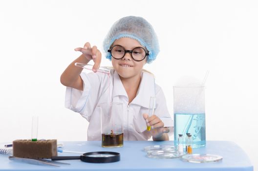 Girl sitting in chemistry class and makes the simplest experiments