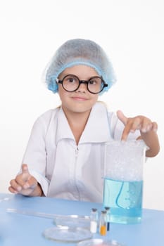 Girl sitting in chemistry class and makes the simplest experiments