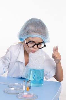 Girl sitting in chemistry class and makes the simplest experiments