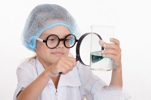 Girl sitting in chemistry class and makes the simplest experiments