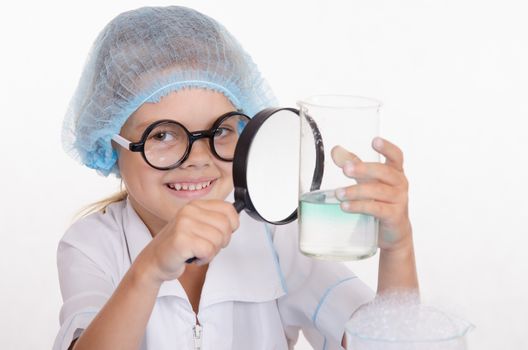 Girl sitting in chemistry class and makes the simplest experiments