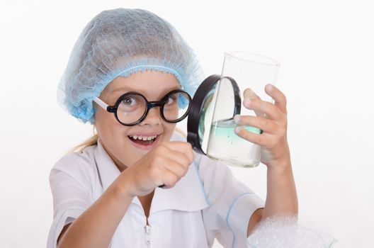 Girl sitting in chemistry class and makes the simplest experiments