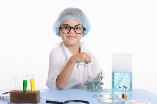Girl sitting in chemistry class and makes the simplest experiments
