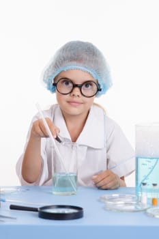 Girl sitting in chemistry class and makes the simplest experiments