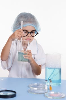 Girl sitting in chemistry class and makes the simplest experiments
