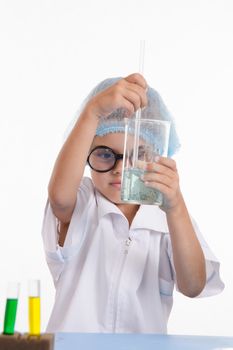 Girl sitting in chemistry class and makes the simplest experiments