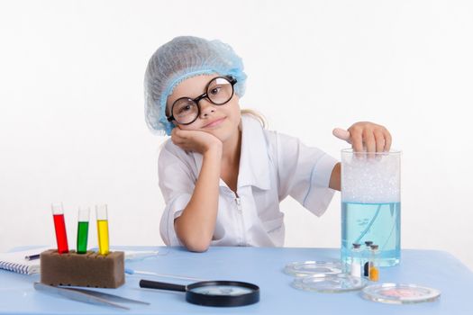 Girl sitting in chemistry class and makes the simplest experiments