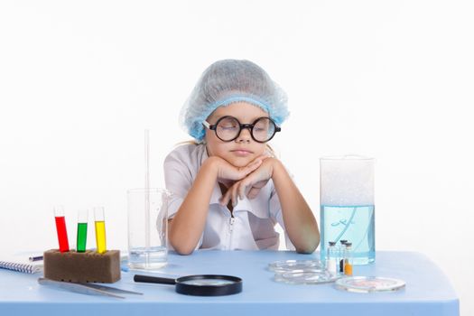 Girl sitting in chemistry class and makes the simplest experiments