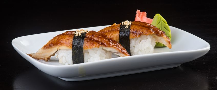 japanese cuisine. sushi unagi on background