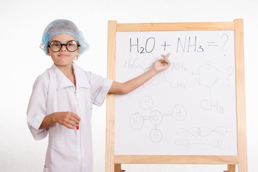 Five-year girl chemist standing at an easel in a bathrobe