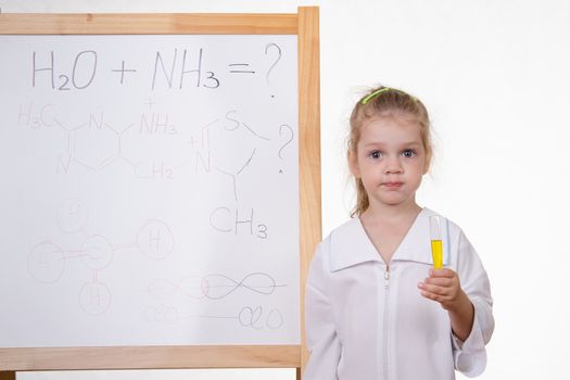 Three year old girl chemist standing at blackboard robe