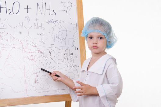 Three year old girl chemist standing at blackboard robe