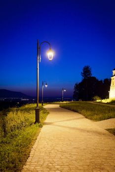 Alley arround old  fortress "Cetatuia" illuminated at night, Brasov, Romania
