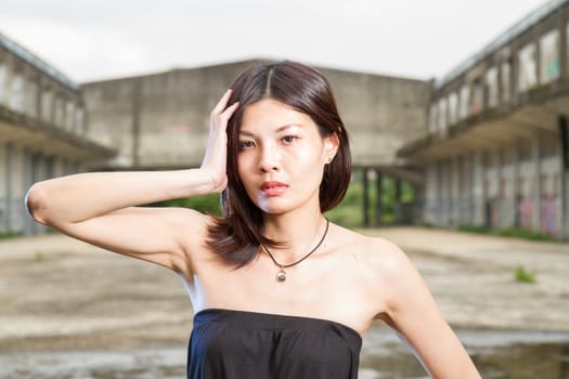 Chinese woman in an old abandoned building