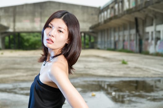 Chinese woman in an old abandoned building