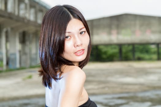 Chinese woman in an old abandoned building