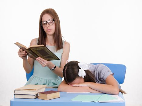 The teacher teaches student who fell asleep from boredom