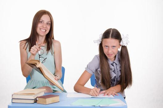 The teacher is angry with the student sitting with him at the table