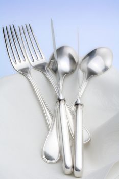 silverware - closeup of elegant knife fork and spoon on white cloth