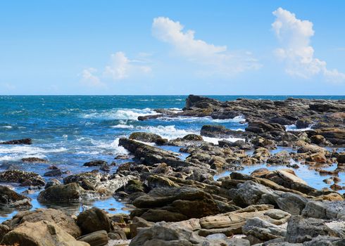 Tropical rocky beach with coconut palm trees, sandy beach and ocean. Tangalle, Southern Province, Sri Lanka, Asia.