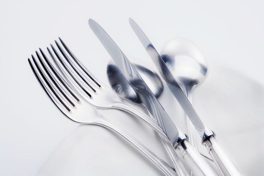 silverware - closeup of elegant knife fork and spoon on white cloth