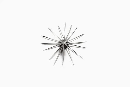 frontal closeup of silver whisk isolated on white background