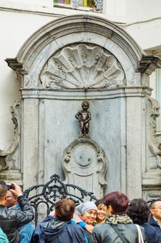 BRUSSELS - OCTOBER 7, 2014: Manneken Pis sculpture on October 7, 2014 in Brussels, Belgium. It's a landmark small bronze sculpture in Brussels, depicting a naked little boy urinating into a fountain's basin.