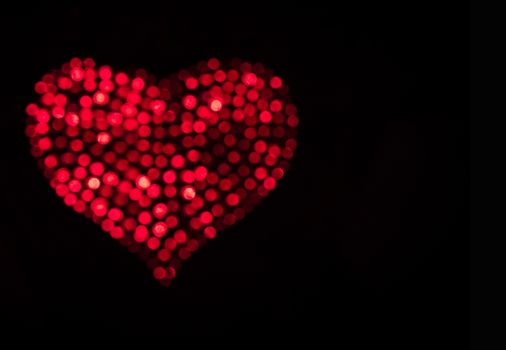 Red heart on black background.