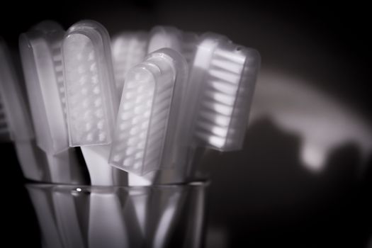 Toothbrushes in a glass. Black background.