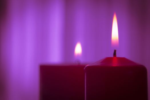 Red candle flame on purple background.