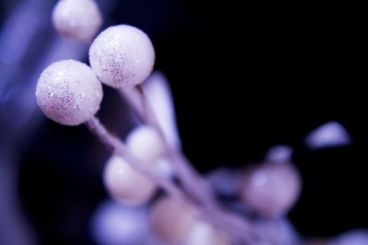 Christmas scene with bright white and blue balls on black background. Horizontal. Space.